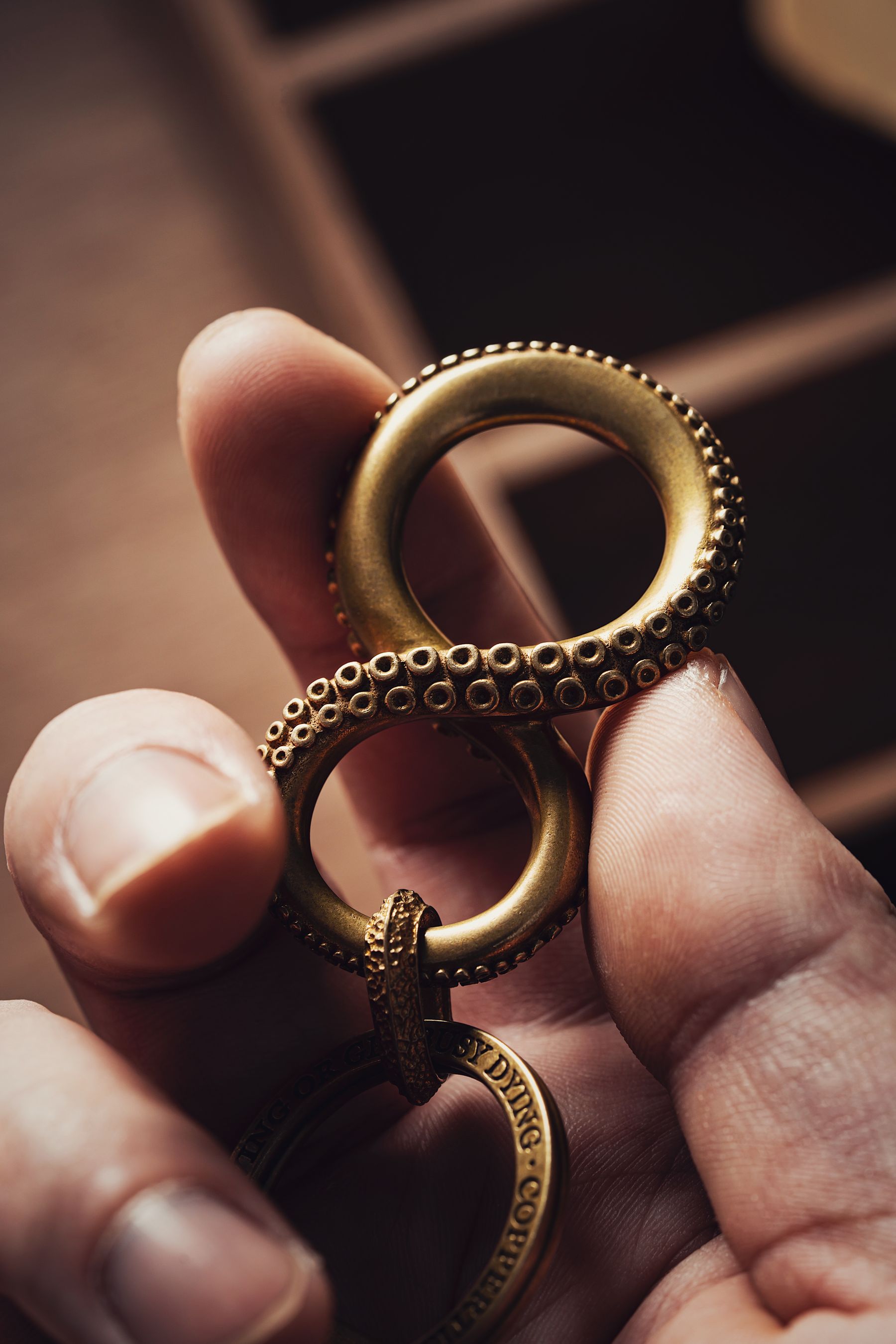 Brass keyring held between fingers